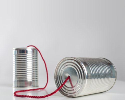 Can telephone with red wire. Conceptual communication image.
